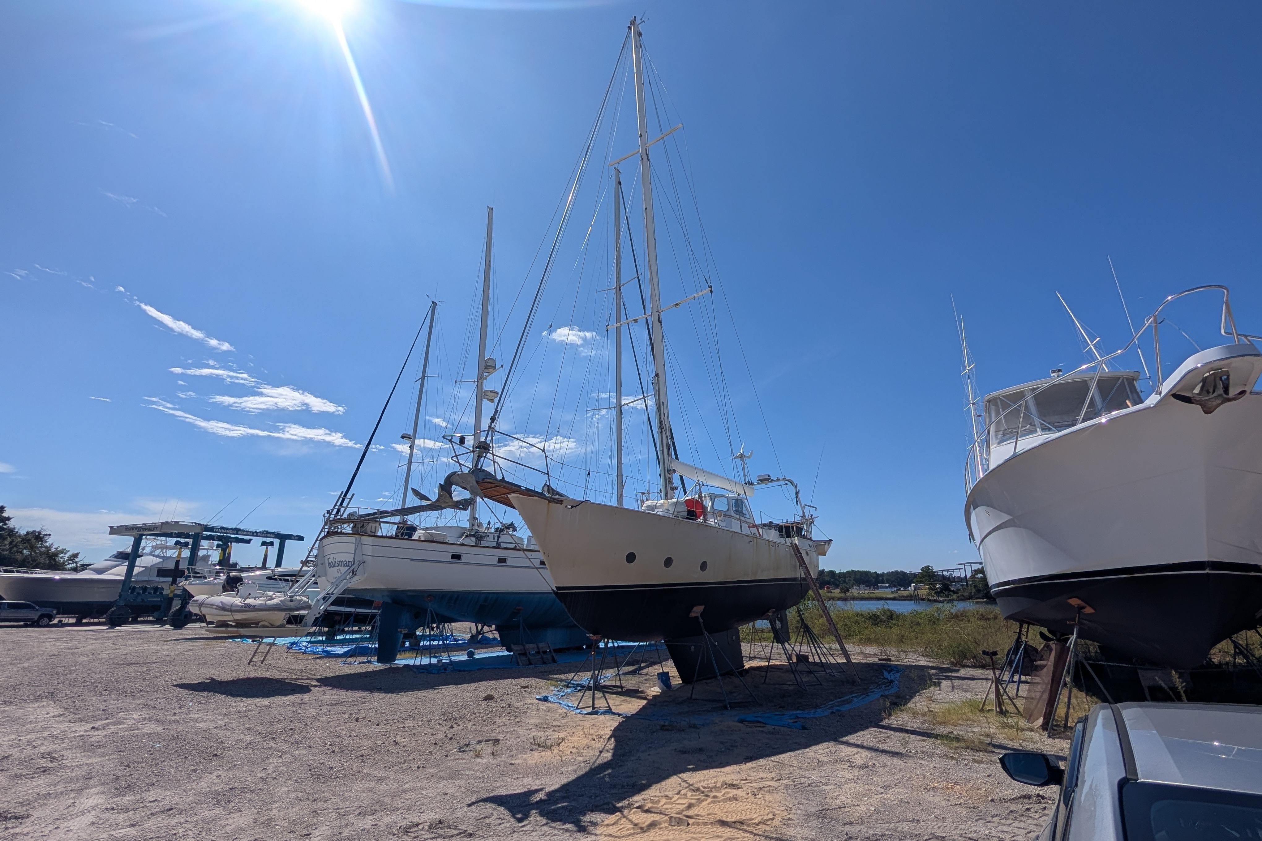 Bruce Bingham Custom 47 Steel Hull 1992 sailboat in dry dock under clear blue sky.