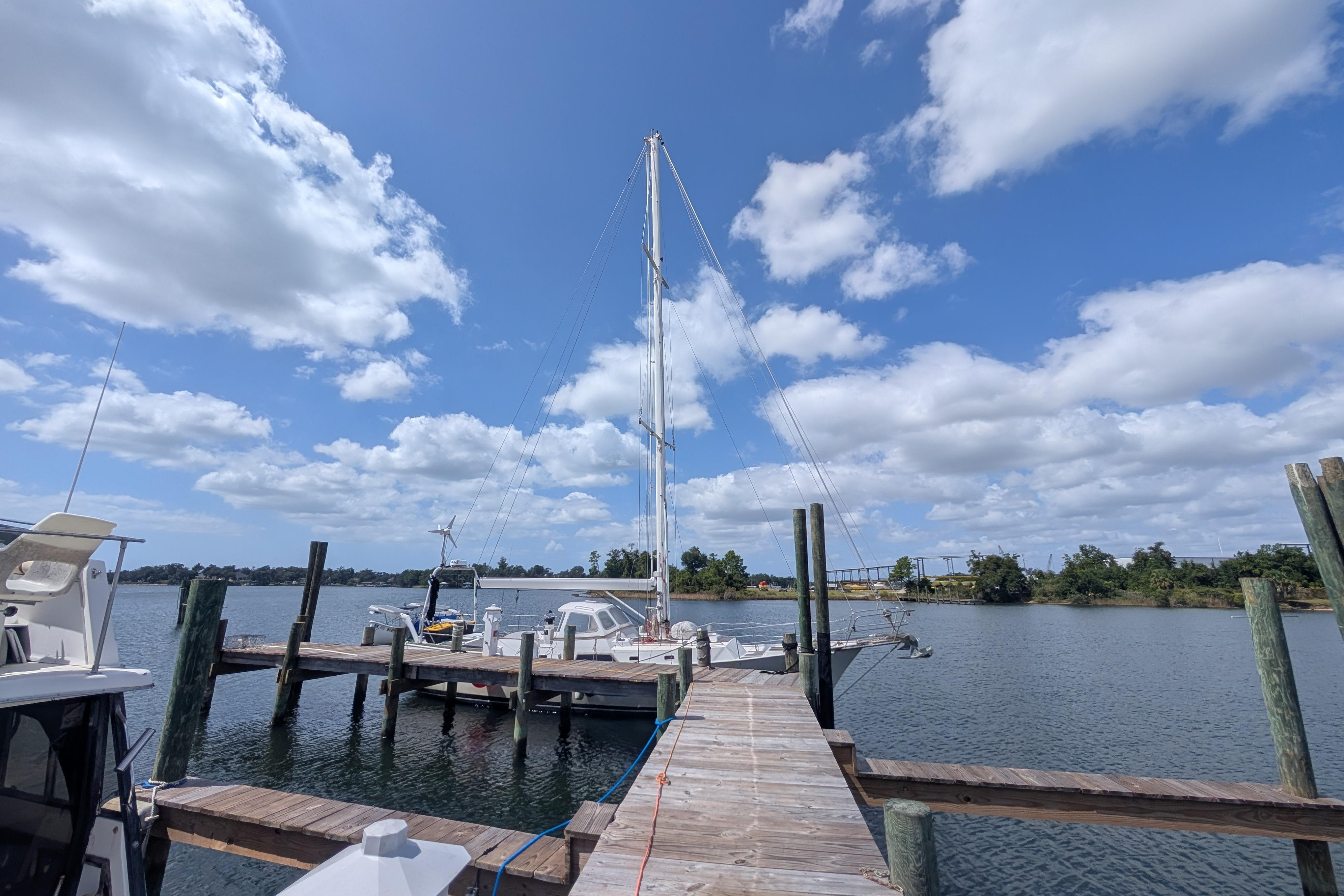 Docked sailboat under blue sky, Bruce Bingham Custom 47, Steel Hull 47, 1992 model.