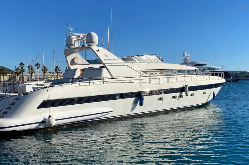  Yacht Photos Pics Luxury 1996 Overmarine Mangusta 100 yacht docked in a sunny marina.
