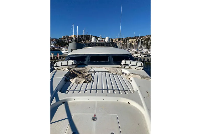 Yacht Photos Pics 1996 Overmarine Mangusta 100 yacht docked in a marina under clear blue skies.