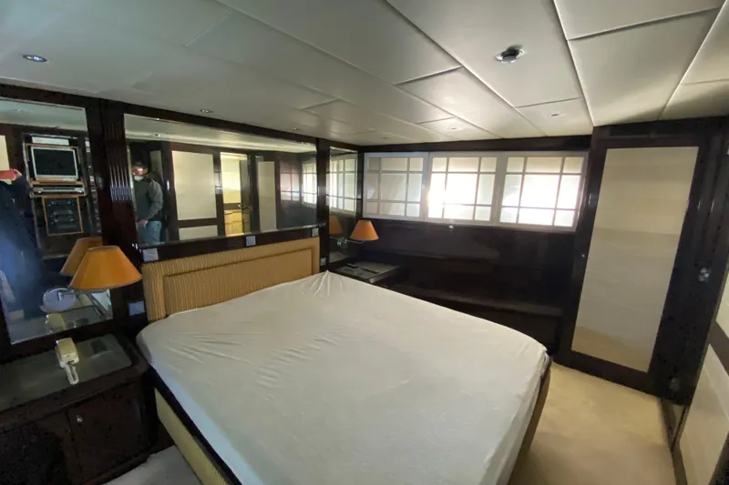  Yacht Photos Pics Luxurious bedroom interior of 1996 Overmarine Mangusta 100 yacht with elegant furnishings.