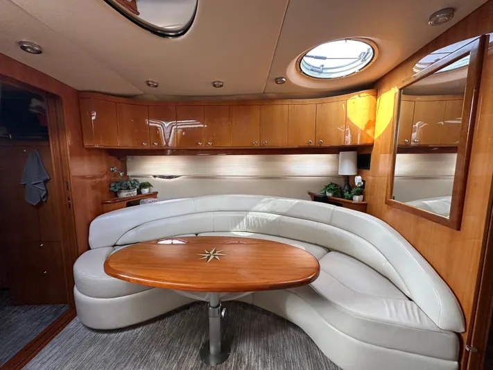 Irish Wake Yacht Photos Pics Luxurious interior of 2005 Regal 4260 COMMODORE yacht with elegant seating and wooden table.