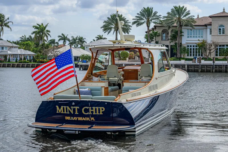 Mint Chip Yacht Photos Pics 2017 Hinckley Picnic Boat 37 MKIII cruising with American flag, Delray Beach backdrop.