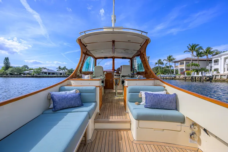 Mint Chip Yacht Photos Pics 2017 Hinckley Picnic Boat 37 MKIII with elegant seating, docked by waterfront homes.