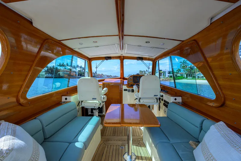 Mint Chip Yacht Photos Pics Interior of 2017 Hinckley Picnic Boat 37 MKIII with elegant wood finish and blue seating.