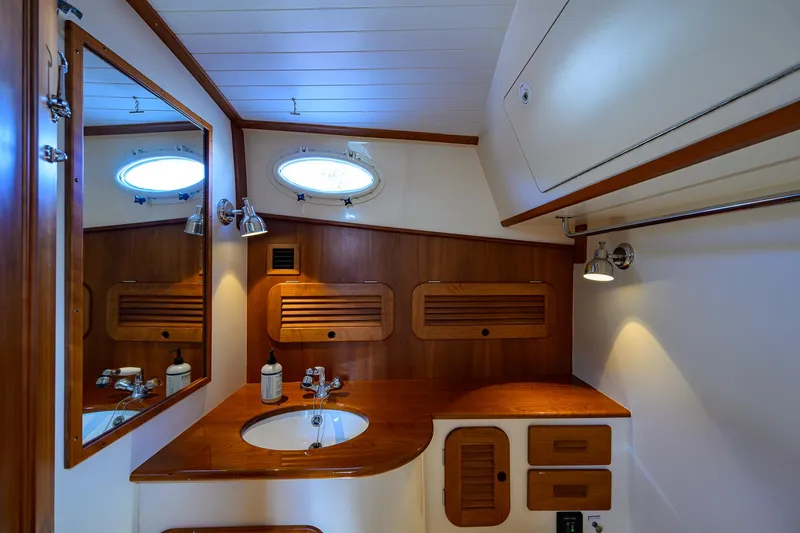 Mint Chip Yacht Photos Pics Elegant 2017 Hinckley Picnic Boat 37 MKIII bathroom with wooden cabinetry and round porthole.