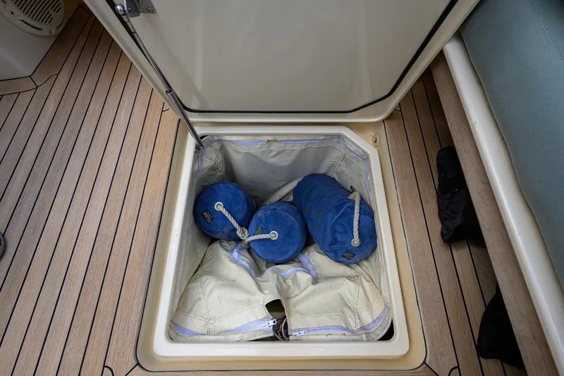 Mint Chip Yacht Photos Pics Storage compartment on 2017 Hinckley Picnic Boat 37 MKIII with blue fenders and canvas.