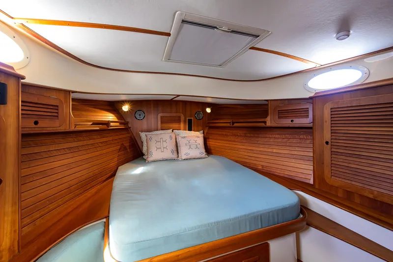 Mint Chip Yacht Photos Pics 2017 Hinckley Picnic Boat 37 MKIII cabin with wooden interior and cozy bed.
