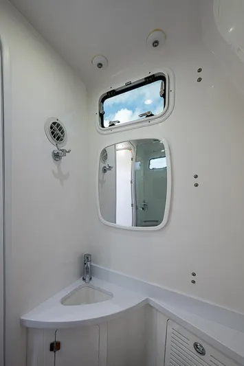  Yacht Photos Pics 2023 HCB 53 Sueños boat bathroom with modern fixtures and a small window.