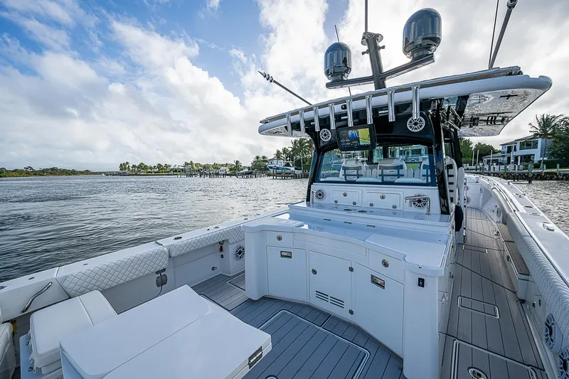  Yacht Photos Pics 2023 HCB 53 Sueños boat with spacious deck and modern amenities on a scenic waterfront.