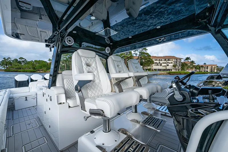  Yacht Photos Pics Luxury interior of 2023 HCB 53 Sueños boat with plush seating and modern controls.