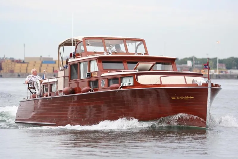 Allez Yacht Photos Pics 1930 Chris-Craft Commuter boat cruising on water, showcasing classic wooden design.