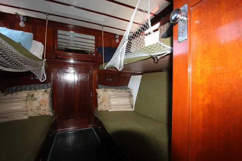 Allez Yacht Photos Pics Interior of a 1930 Chris-Craft Commuter boat with wooden paneling and cozy bunks.