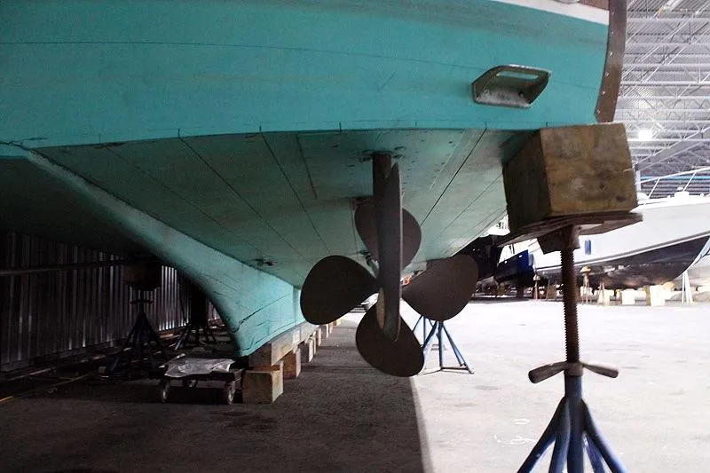 Allez Yacht Photos Pics 1930 Chris-Craft Commuter boat underside with propeller in storage.