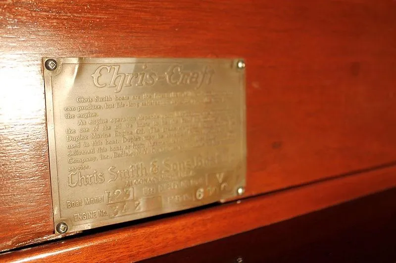 Allez Yacht Photos Pics 1930 Chris-Craft Commuter boat plaque on wooden surface, displaying model and engine details.