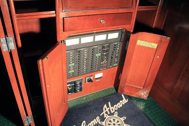 Allez Yacht Photos Pics 1930 Chris-Craft Commuter electrical panel with wooden cabinetry and welcome mat.