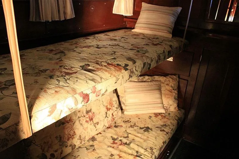 Allez Yacht Photos Pics 1930 Chris-Craft Commuter interior with floral bunk beds and wooden paneling.