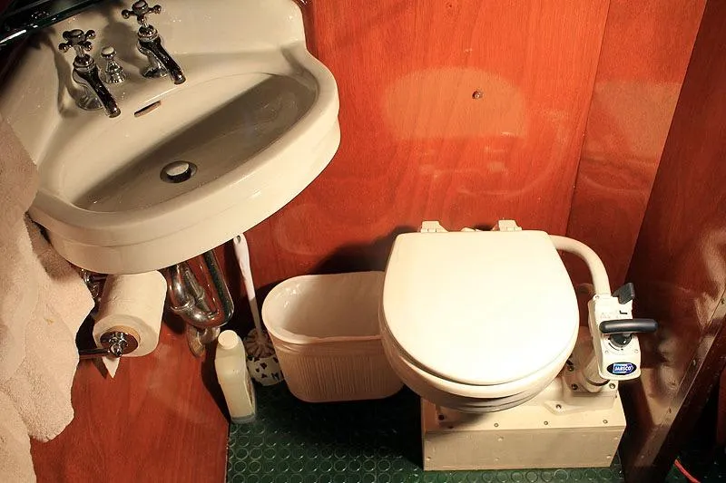 Allez Yacht Photos Pics 1930 Chris-Craft Commuter bathroom with vintage sink and toilet, wooden paneling.