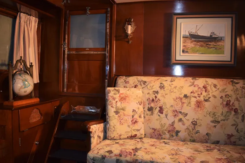 Allez Yacht Photos Pics Interior of 1930 Chris-Craft Commuter with floral upholstery, globe, and nautical painting.