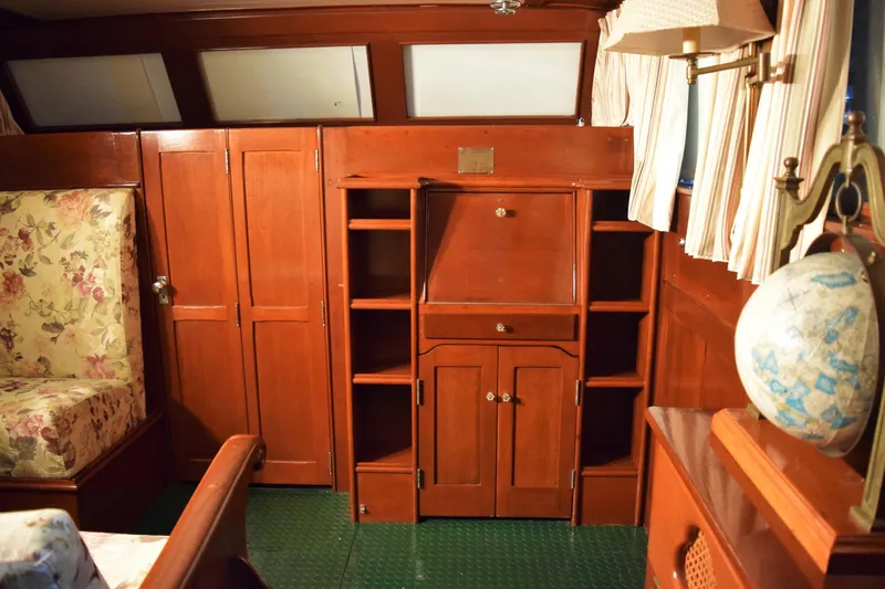 Allez Yacht Photos Pics Interior of 1930 Chris-Craft Commuter boat with wooden cabinetry and floral upholstery.