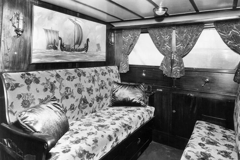 Allez Yacht Photos Pics Luxurious 1930 Chris-Craft Commuter interior with floral upholstery and nautical artwork.