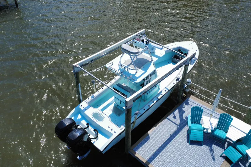  Yacht Photos Pics Aerial view of 2018 Conch 30 boat docked beside turquoise chairs on a sunny day.