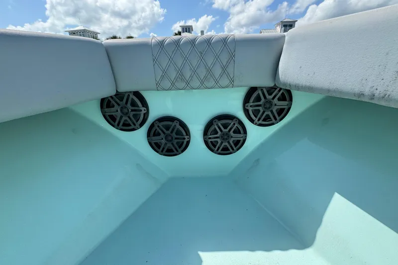  Yacht Photos Pics 2018 Conch 30 boat interior with speakers and cushioned seating under a blue sky.