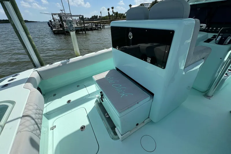  Yacht Photos Pics 2018 Conch 30 boat interior with seating and storage, docked by the water.