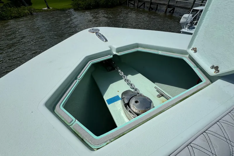  Yacht Photos Pics Open anchor locker on 2018 Conch 30 boat, showing chain and winch mechanism.