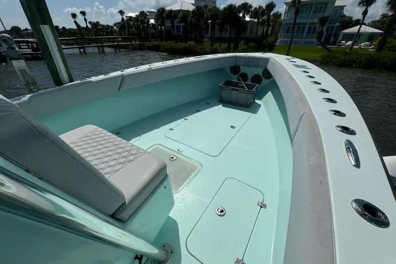  Yacht Photos Pics 2018 Conch 30 boat interior with seating and storage, docked near waterfront homes.