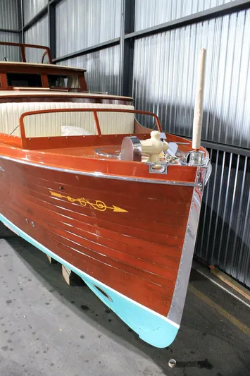 Allez Yacht Photos Pics 1930 Chris-Craft Commuter boat with polished wood finish in a storage facility.