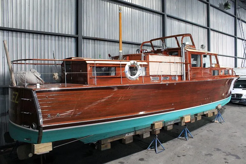 Allez Yacht Photos Pics 1930 Chris-Craft Commuter boat in a warehouse, showcasing classic wooden design.
