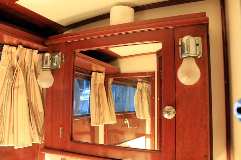 Allez Yacht Photos Pics Interior of 1930 Chris-Craft Commuter with wooden cabinetry and vintage light fixtures.