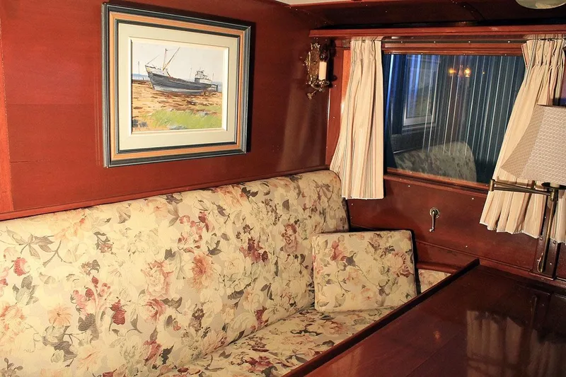 Allez Yacht Photos Pics Vintage 1930 Chris-Craft Commuter interior with floral upholstery and nautical artwork.