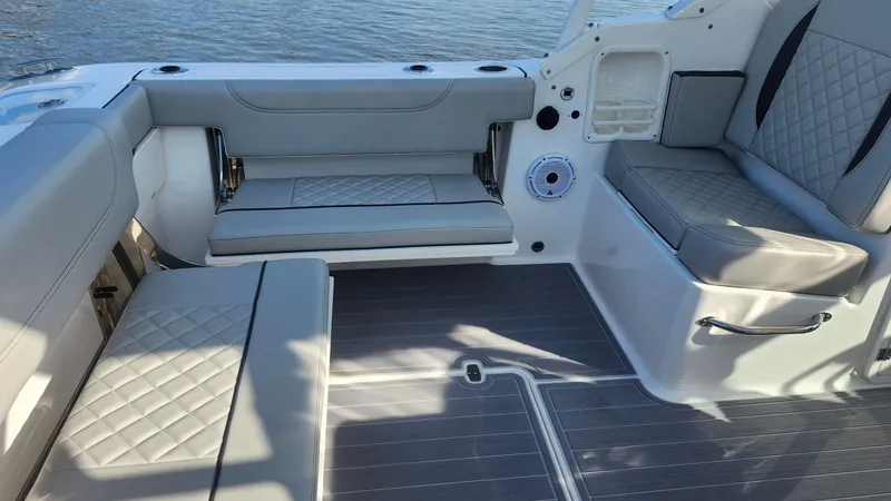  Yacht Photos Pics 2024 Pursuit DC 266 Dual Console boat interior with gray cushioned seating and sleek design.