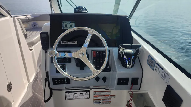  Yacht Photos Pics 2024 Pursuit DC 266 Dual Console boat dashboard with steering wheel and controls.