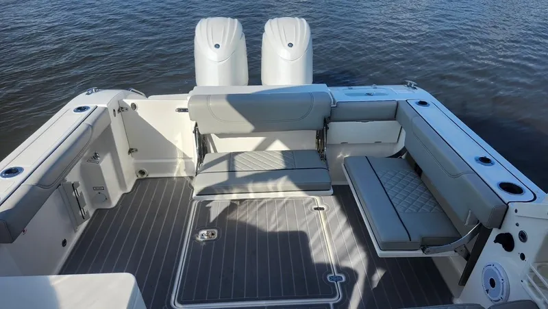  Yacht Photos Pics 2024 Pursuit DC 266 Dual Console boat interior with seating and twin engines on water.