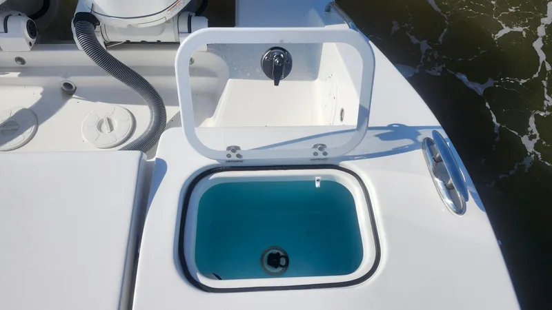  Yacht Photos Pics 2024 Pursuit DC 266 Dual Console boat with open livewell, showcasing sleek design and functionality.