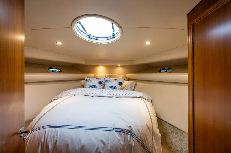  Yacht Photos Pics Luxurious bedroom interior of 2004 Riviera 37 Flybridge yacht with cozy bedding.