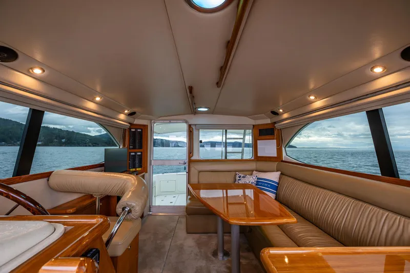  Yacht Photos Pics Interior of 2004 Riviera 37 Flybridge yacht with elegant seating and ocean view.