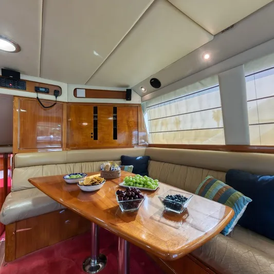  Yacht Photos Pics Luxurious 2005 Riviera 47 Convertible Series II yacht interior with dining area and snacks.