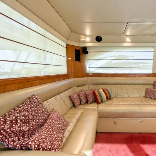  Yacht Photos Pics Luxurious interior of 2005 Riviera 47 Convertible Series II yacht with plush seating and cushions.