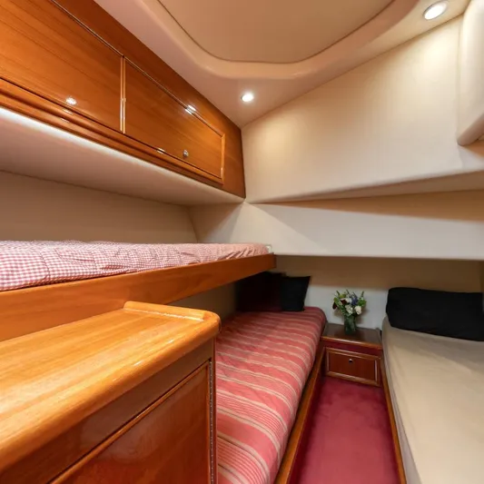 Yacht Photos Pics 2005 Riviera 47 Convertible Series II cabin with bunk beds and elegant wood finish.