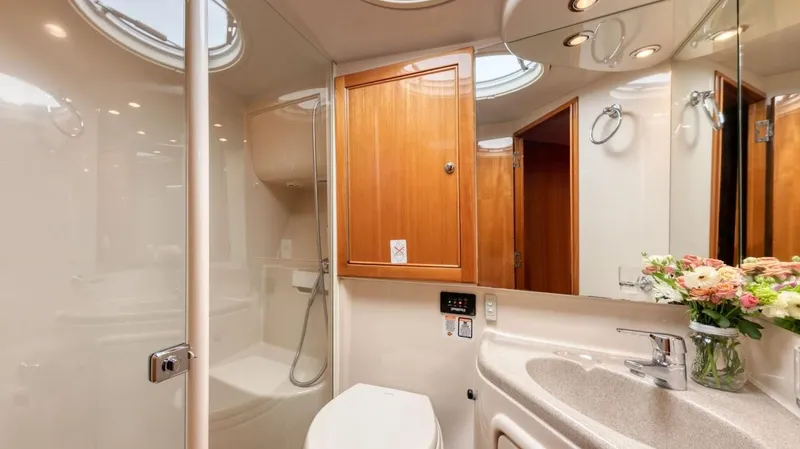  Yacht Photos Pics Luxurious bathroom in 2005 Riviera 47 Convertible Series II yacht, featuring modern fixtures and wood accents.