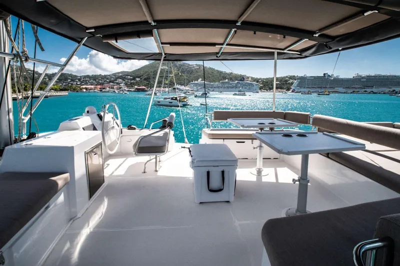 Southern Queen Yacht Photos Pics Luxurious Bali 5.4 catamaran interior, 2022 model, overlooking vibrant marina and turquoise waters.
