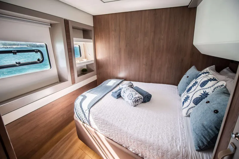 Southern Queen Yacht Photos Pics Luxurious cabin interior of 2022 Bali 5.4 yacht with cozy bedding and ocean view.