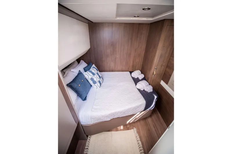 Southern Queen Yacht Photos Pics Cozy cabin interior of 2022 Bali 5.4 yacht with elegant bedding and wooden accents.
