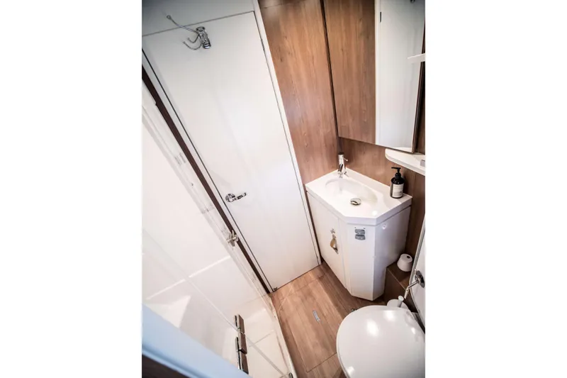 Southern Queen Yacht Photos Pics Compact bathroom in 2022 Bali 5.4 model, featuring modern fixtures and wood accents.