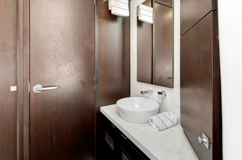 Aqua Toy Yacht Photos Pics Luxurious bathroom interior of 2023 Jupiter 43 Center Console boat, featuring modern sink and mirror.