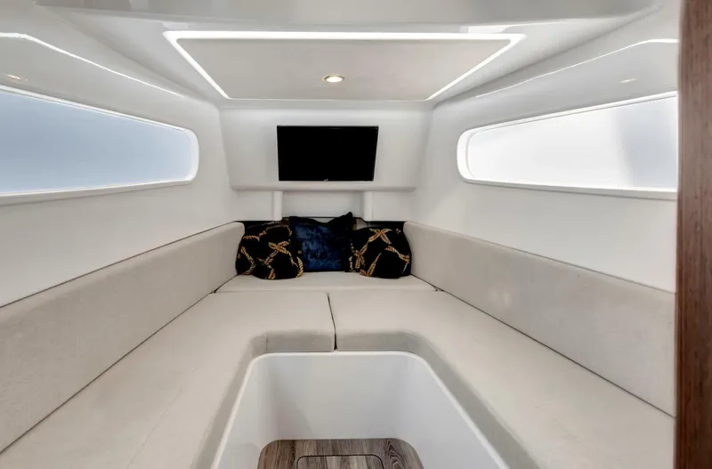 Aqua Toy Yacht Photos Pics Interior of 2023 Jupiter 43 Center Console boat, featuring modern seating and a TV.